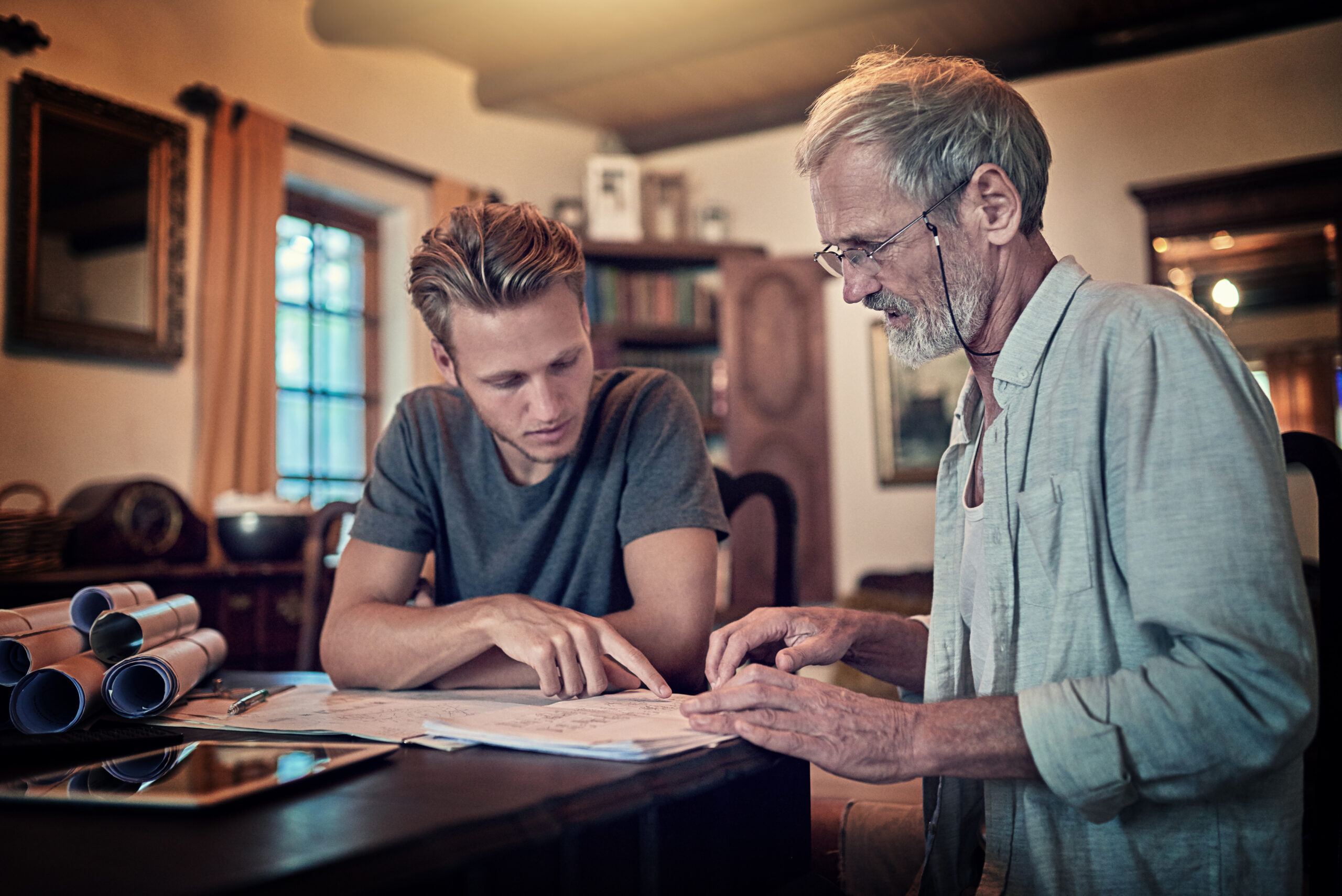 These great minds think alike. Shot of a father and his son work Shot of a father and his son working on a design for their family business at home.